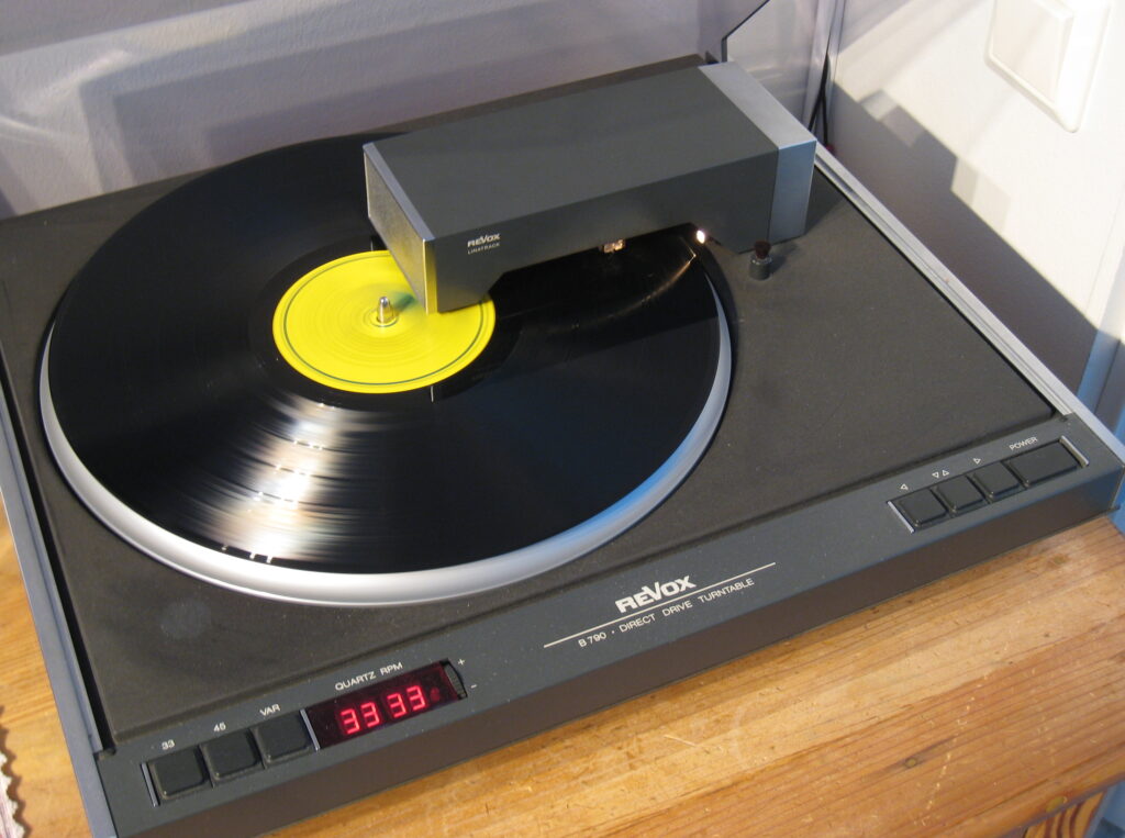 ReVox B790 Turntable, shown here playing a record, the tangential tonearm keeps the phono cartridge at a constant angle