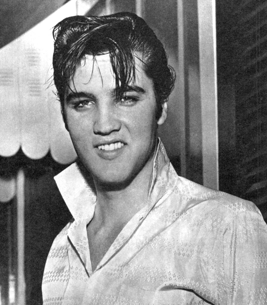 A classic black-and-white portrait of Elvis Presley, the King of Rock and Roll